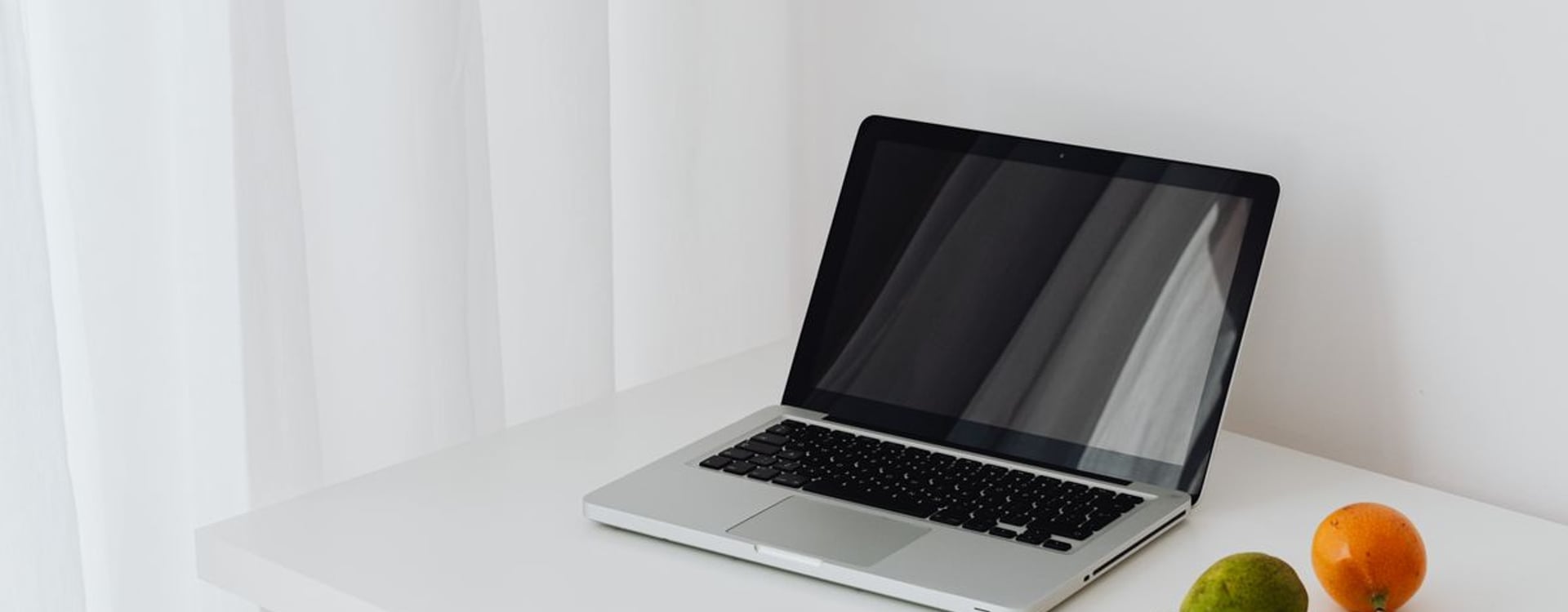 Warm desk setup showing MacBook heat concerns before choosing a MacBook laptop cooler