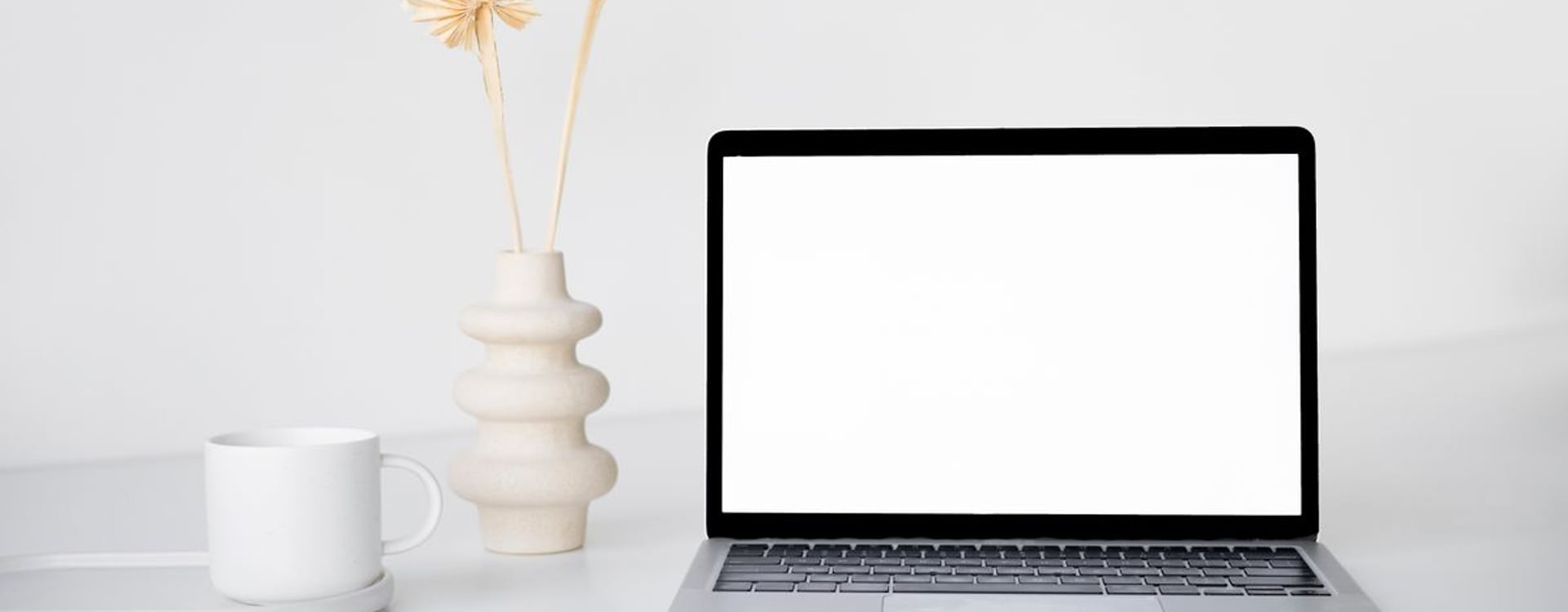 Warm desk setup showing MacBook cooling concerns before choosing a sealed-bottom laptop cooler