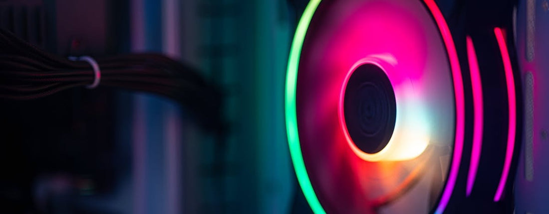 A high-performance Alienware x16 laptop on a desk, glowing in a dimly lit room, emphasizing the intense thermal demands of gaming.