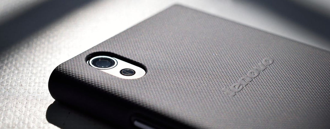 Detailed close-up view of a smartphone with a textured back cover emphasizing modern design and technology.