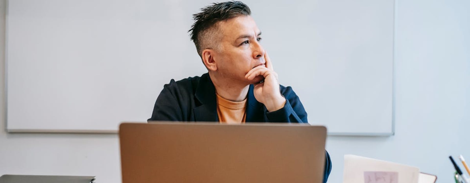 A laptop running a video conference and multiple browser tabs, illustrating common scenarios for cooling laptop challenges.