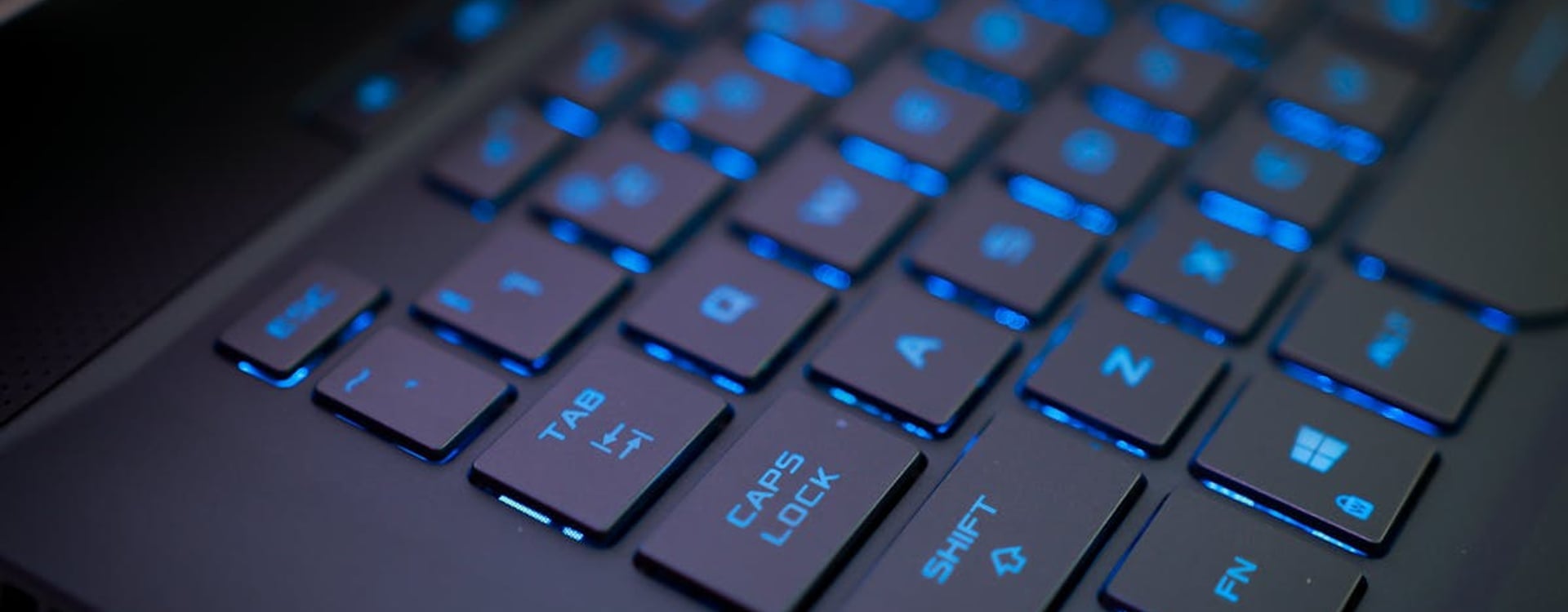 A gaming laptop displaying a vibrant game, sitting on a modern desk in a dimly lit room, highlighting the immersive experience of gaming.