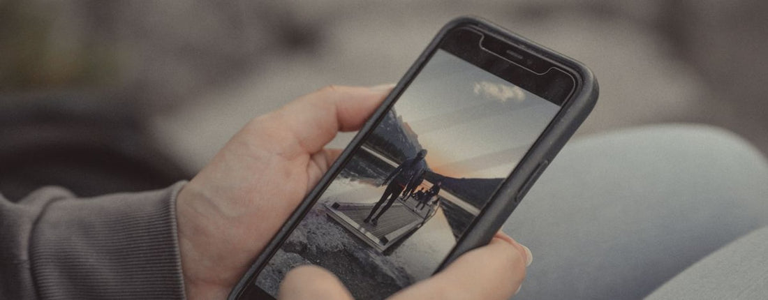Person checking smartphone placement at a desk before planning GameSir G8 Plus phone cooler fit