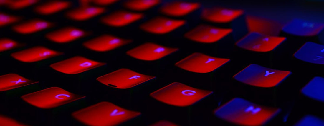 Close-up of a red backlit keyboard, highlighting the vibrant glowing keys.