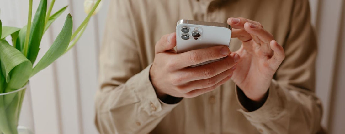 Gamer checking whether a magnetic phone cooler is safe after a warm smartphone session at a dim desk