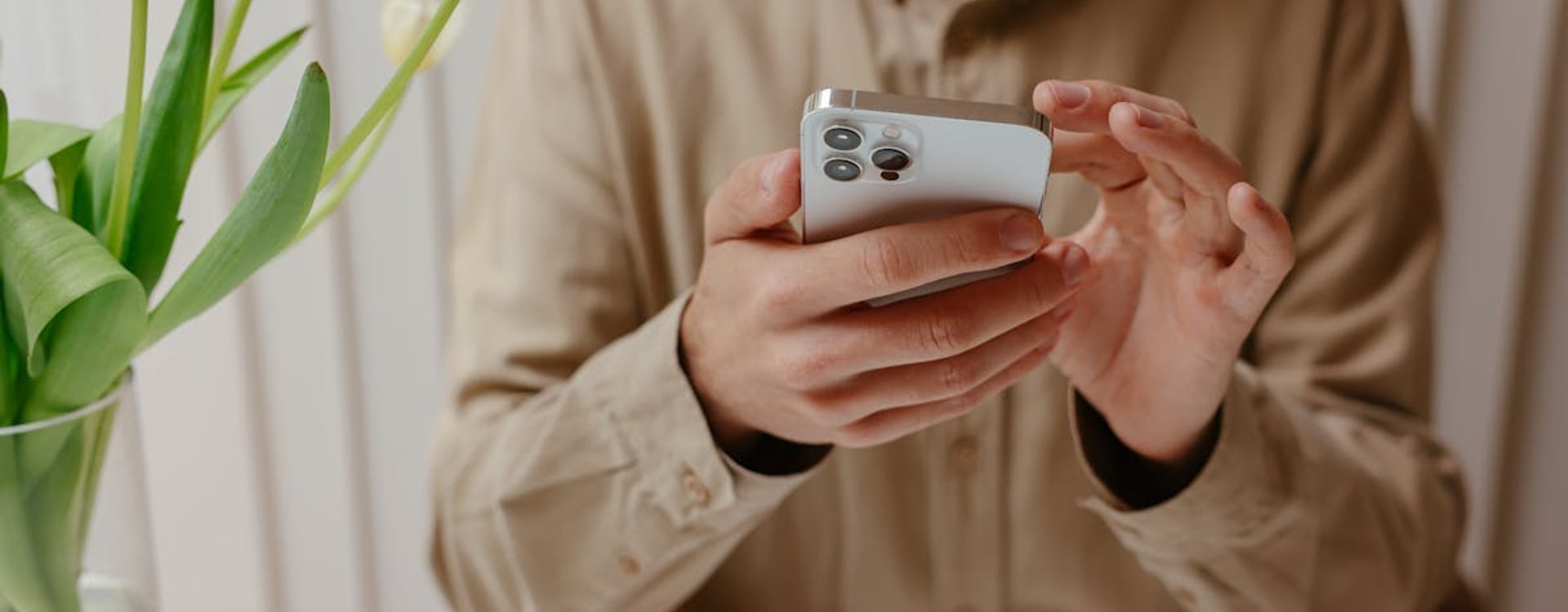 Gamer checking whether a magnetic phone cooler is safe after a warm smartphone session at a dim desk