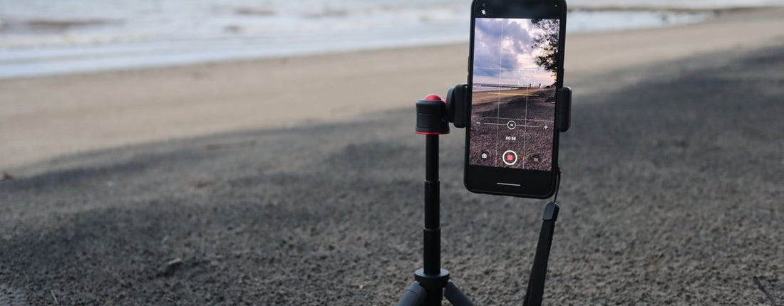 Phone lens recording setup on a tripod in a quiet room prepared for a longer fixed video take