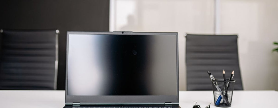Laptop on an office desk for comparing cooling pad fit and controls