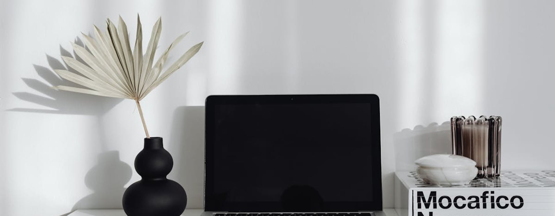 Remote worker on a long video call with a warm MacBook Air, illustrating the need for improved laptop cooling.