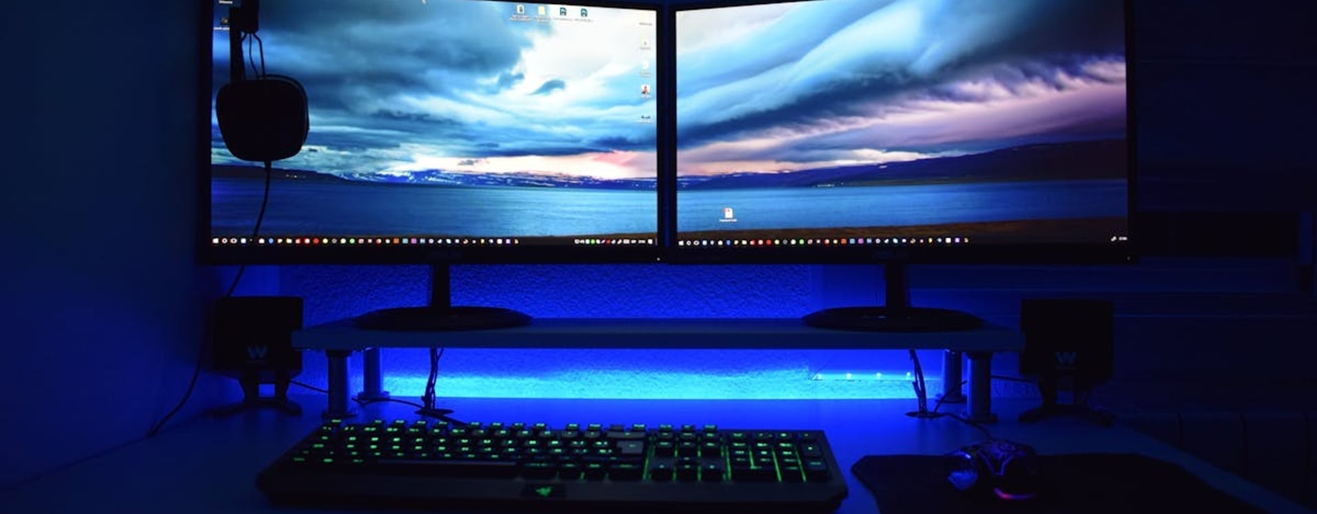A gamer's hands on a Razer Blade 16 laptop keyboard during an intense gaming session, managing the Razer Blade 16 SSD temperature.