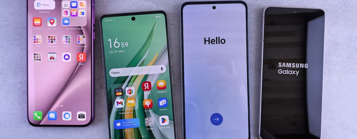 Four modern smartphones showcasing home screens, applications, and startup logos on a sleek surface.